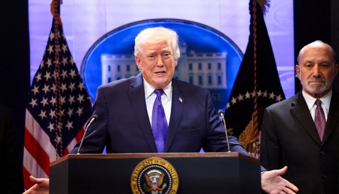 US President Donald Trump, flanked by Secretary of Commerce Howard Lutnick speaks during a press briefing at the White House in Washington, DC, US, February 20, 2026. — Reuters