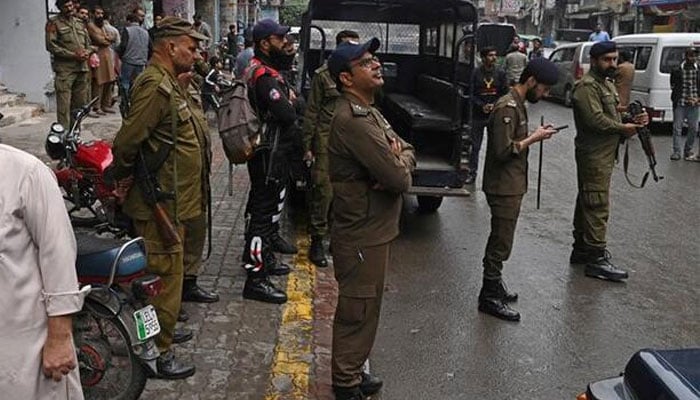 Police personnel patrol a market in Lahore on November 10, 2023. Punjab police registered case against two journalists on July 26 and July 29, 2025. — APP/File