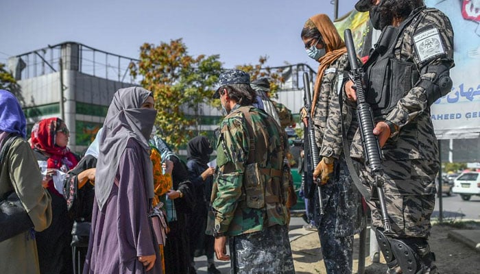 Afghan women take part in a protest in presence of Talibans armed personnel. — AFP/File