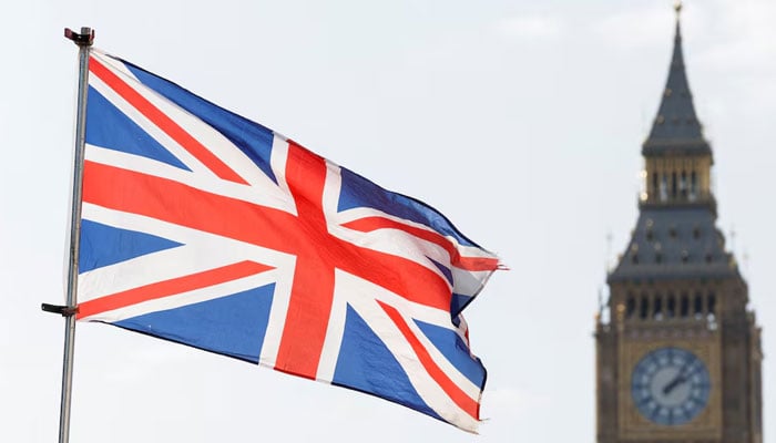The Britains national flag flies next to the Elizabeth Tower, commonly known as Big Ben, in London, Britain, March 23, 2022. — Reuters