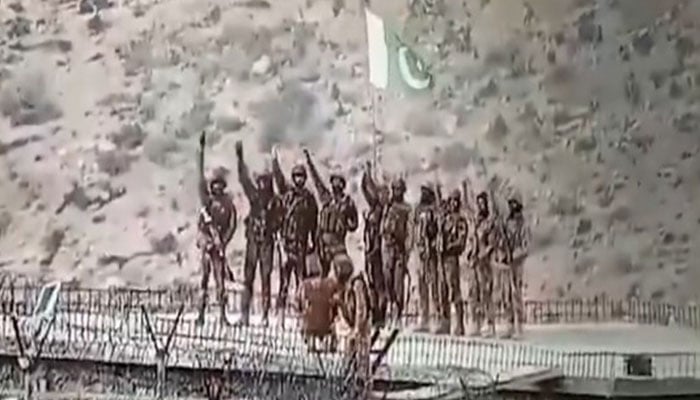 Pakistan Army soldiers raise national flag at a captured Afghan Taliban checkpost at border on February 27, 2026. — X@PTVNewsOfficial