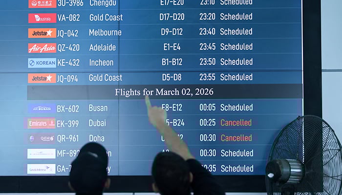 Passengers looks at departure board at I Gusti Ngurah Rai International Airport as some flights to Dubai and Doha cancelled following strikes on Iran launched by the United States and Israel, in Kuta, Bali, Indonesia, March 1, 2026. — Reuters