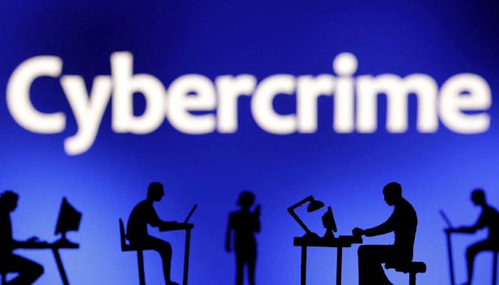 Figurines with computers and smartphones are seen in front the word Cybercrime in this illustration taken, February 19, 2024. — Reuters