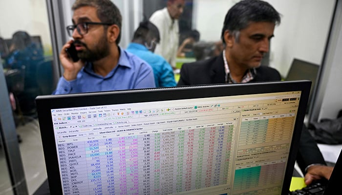 Pakistani stockbrokers work during a trading session at the Pakistan Stock Exchange (PSX) in Karachi on June 11, 2025. — AFP