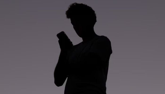 A man uses a mobile phone, in Brisbane, Australia, December 8, 2025. — Reuters