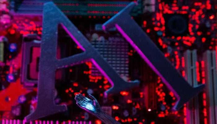 AI (Artificial Intelligence) letters and robot hand are placed on computer motherboard in this illustration taken, June 23, 2023. — Reuters