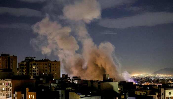 A smoke plume rises following a missile strike on a building in Tehran on March 1, 2026. — AFP