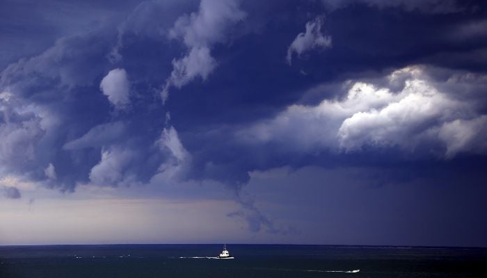 Boats head into shore as storm clouds move along the coast towards the city of Sydney, Australia, November 6, 2015. — Reuters
