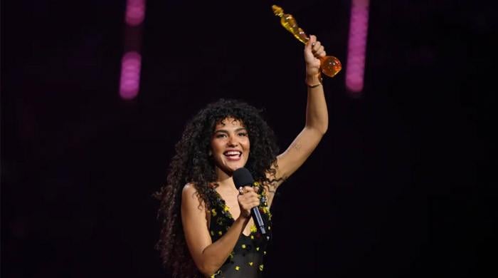 Olivia Dean flexes four BRITs trophies in inspiring message