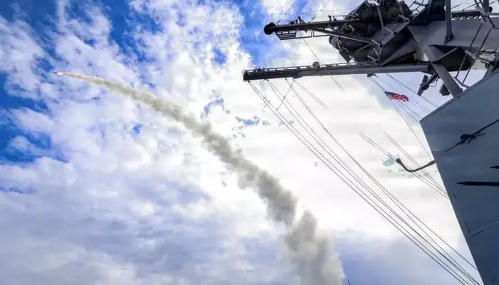 This US Navy handout photo shows the Arleigh Burke-class guided-missile destroyer USS Thomas Hudner (DDG 116) firing a Tomahawk land attack missile in support of Operation Epic Fury. — AFP