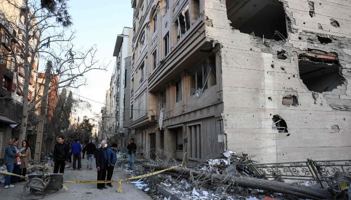Most Americans oppose Iran strikes, doubt Trump has plan 8 Residents stand on a street beside damaged residential buildings near Niloufar square in Tehran during the ongoing joint US-Israeli military campaign on Iran on March 2, 2026.