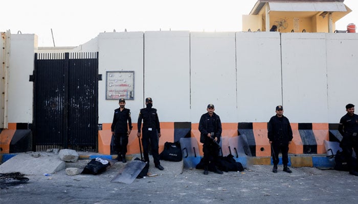 Police officers stand guard outside US Consulate General in Karachion March 2, 2026. — Reuters