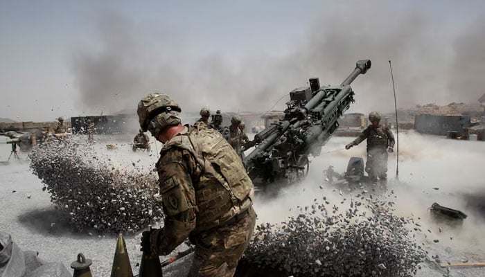 US Army soldiers from the 2nd Platoon, B battery 2-8 field artillery, fire a howitzer artillery piece at Seprwan Ghar forward fire base in Panjwai district, Kandahar province southern Afghanistan, June 12, 2011. — Reuters