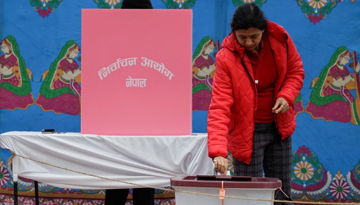 A woman votes at a polling station in Patan Durbar Square during the general election in Lalitpur, Nepal, March 5, 2026. — Reuters