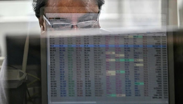 A stockbroker monitors share prices on a computer at the Pakistan Stock Exchange (PSX) in Karachi on May 7, 2025. — AFP