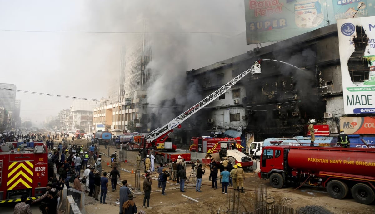 Smoke rises as firefighters spray water to extinguish a massive fire that broke out in the Gul Plaza Shopping Centre building, in Karachi on January 18, 2026. — Reuters