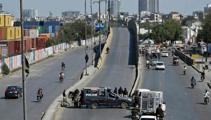 Police stand guard along a street leading to the US consulate in Karachi on March 4, 2026. — AFP
