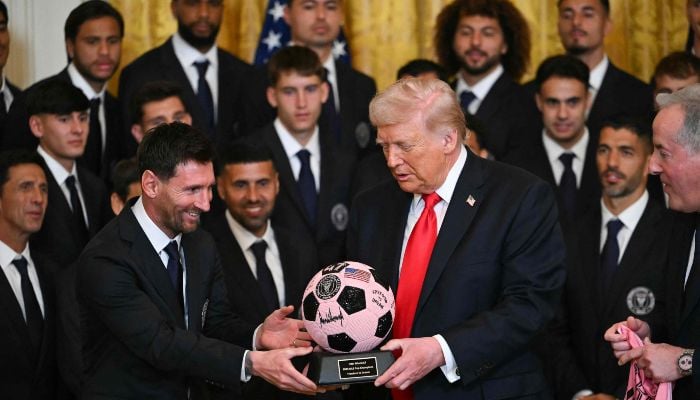 Argntinian star Lionel Messi hands US President Donald Trump during an event for Inter Miami CF, winners of the 2025 Major League Soccer Cup, in the East Room of the White House in Washington, DC, on March 5, 2026. — AFP
