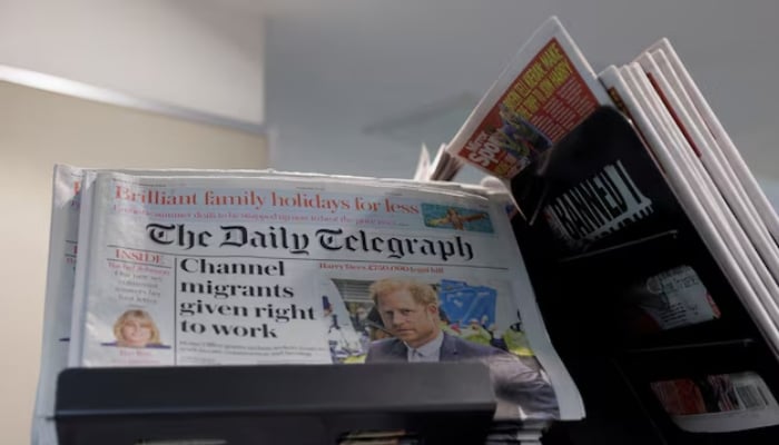 Copies of The Daily Telegraph are displayed on a rack in a supermarket in London, Britain. — Reuters/File