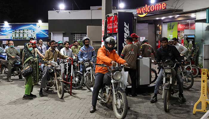 People wait for their turn to get fuel at a petrol station, amid the US and Israeli conflict in Iran, in Karachi, March 6, 2026. — Reuters
