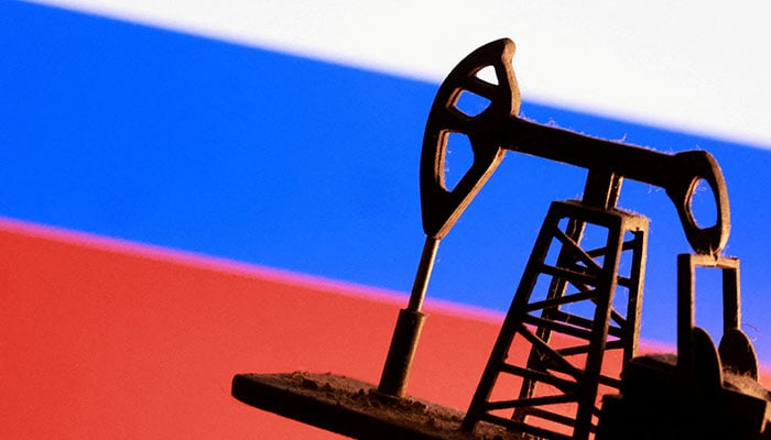 A model of an oil pump is seen in front of a Russian flag in this illustration on January 9, 2026. — Reuters