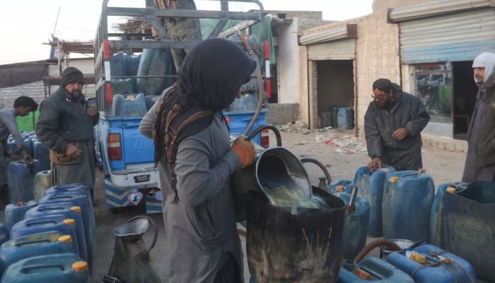 A man fills a canister with petrol, brought from Iran, amid the US-Israel conflict with Iran, at a roadside depot on the outskirts of Quetta, March 4, 2026. — Reuters