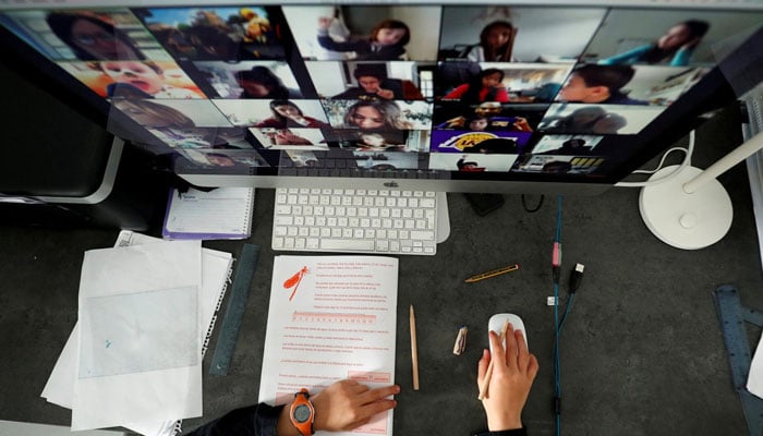 This representational image shows a student takes classes online with his companions using the Zoom app at home in El Masnou, north of Barcelona, Spain April 2, 2020. — Reuters