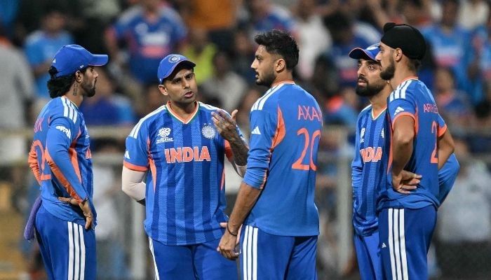 Indias Tilak Varma, captain Suryakumar Yadav, Axar Patel, Varun Chakravarthy and Arshdeep Singh gather during the 2026 ICC Mens T20 Cricket World Cup semi-final match between India and England at the Wankhede Stadium in Mumbai on March 5, 2026. — AFP