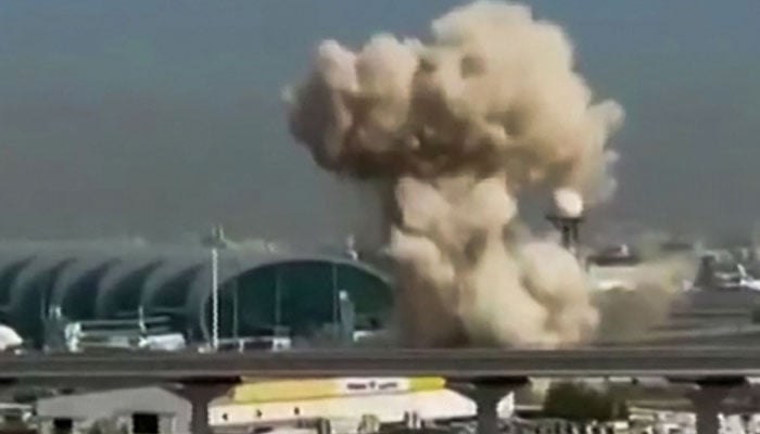 This video grab taken from UGC images posted on social media on March 7, 2026 shows smoke rising from the Dubai International Airport. Dubai airport, the world´s busiest for international traffic, suspended operations on March 7, 2026. — AFP