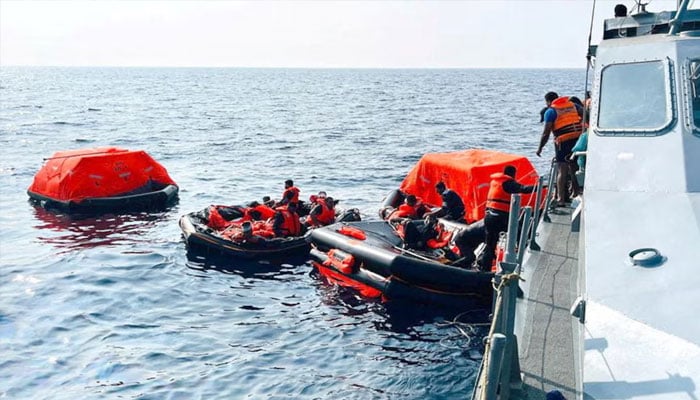 Sri Lanka Navy personnel assist Iranian sailors during a rescue operation after responding to a distress call from their vessel, the Iranian military ship, IRIS Dena, within Sri Lanka’s maritime search and rescue region, in the Indian Ocean, March 4. — Reuters