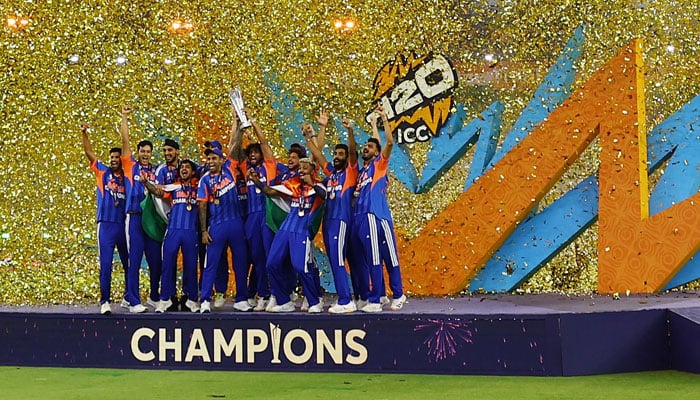 Indian players celebrate on the podium with the trophy after winning the ICC Mens T20 World Cup  2026 after defeating New Zealand in the final. — Reuters