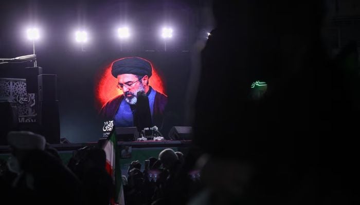 A picture of Irans new supreme leader, Mojtaba Khamenei, is displayed on a screen in Tehran, amid the US-Israeli conflict with Iran, in Tehran, Iran, March 9, 2026. — Reuters