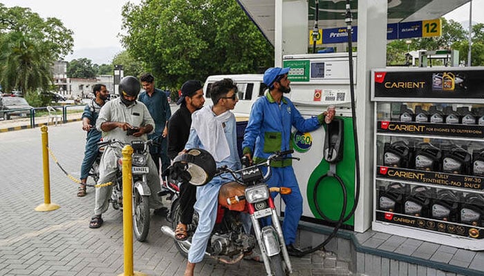 An employee fills the tank of a motorbike at a fuel station in Islamabad on June 16, 2025. — AFP