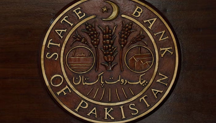 The logo of the State Bank of Pakistan is pictured on a reception desk at the banks head office in Karachi. — Reuters/File