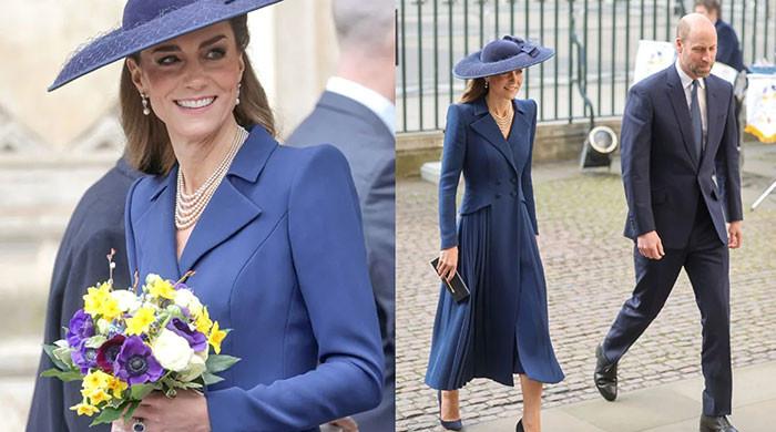 Kate steals the spotlight in 80s-inspired navy dress holding flowers