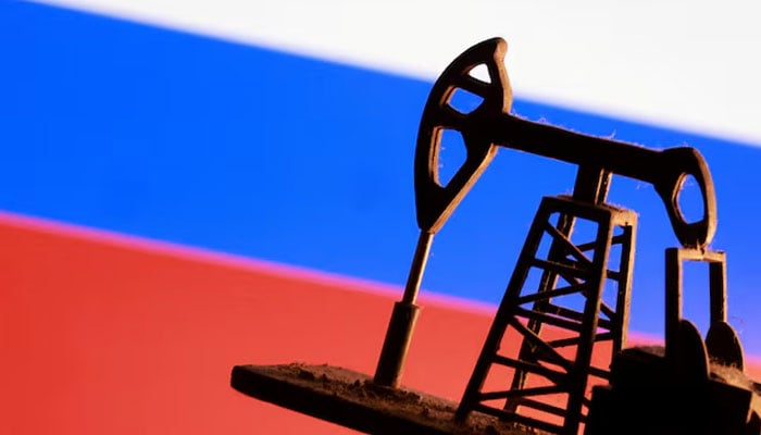 A model of an oil pump is seen in front of a Russian flag in this illustration taken January 9, 2026. — Reuters