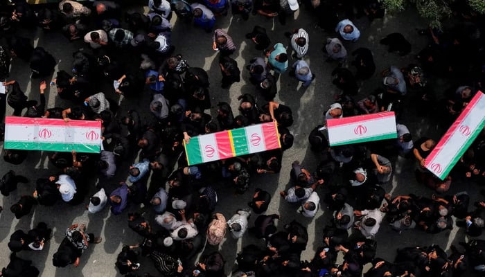 People carry coffins as they attend the funeral of the victims following an Israeli strike on a school, amid the US-Israeli conflict with Iran, in Minab, Iran, March 3, 2026. — Reuters