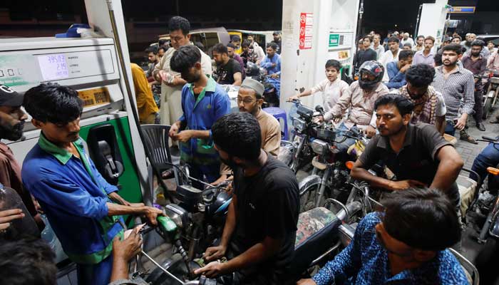 People wait their turn to get fuel at a petrol station, in Karachi, Pakistan June 2, 2022. — Reuters