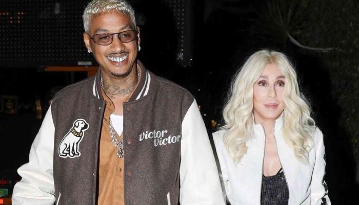 Cher flashes a huge diamond ring and a gold band on her ring finger