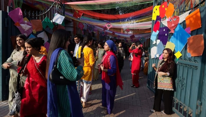 People take selfies with kites on display, to mark Basant, a kite-flying festival, in Lahore on February 6, 2026. — Reuters