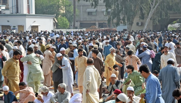 Muslims greet each other after offering prayers of Eid ul Fitr at the Eidgah Sharif shrine in Rawalpindi. — Online/File