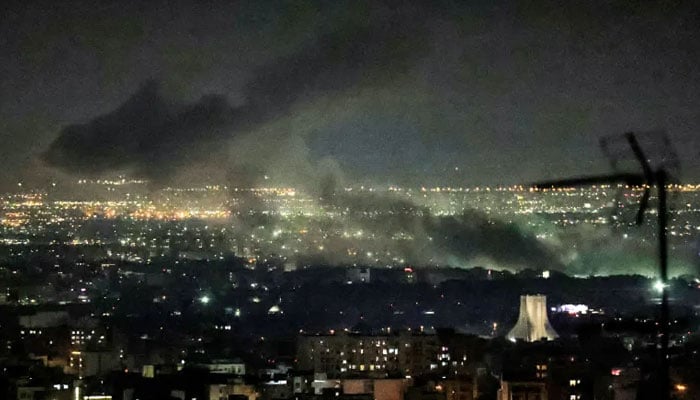 Smoke plumes billow from the site of airstrikes near Azadi Tower in western Tehran on March 10, 2026. — AFP