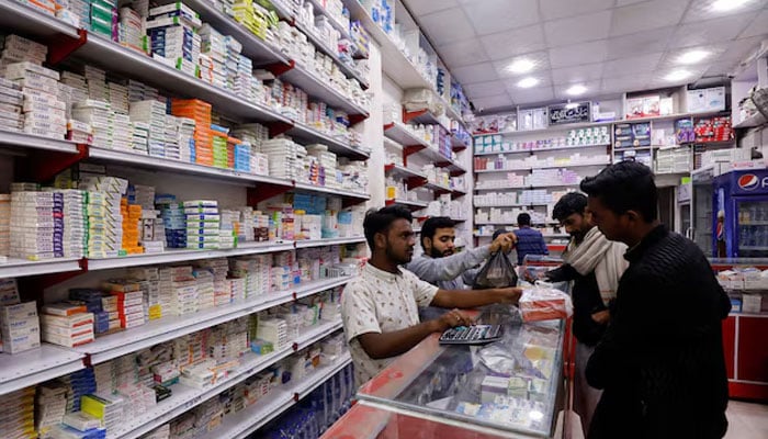 Customers buy medicine from a medical supply store in Karachi, Pakistan February 9, 2023. — Reuters