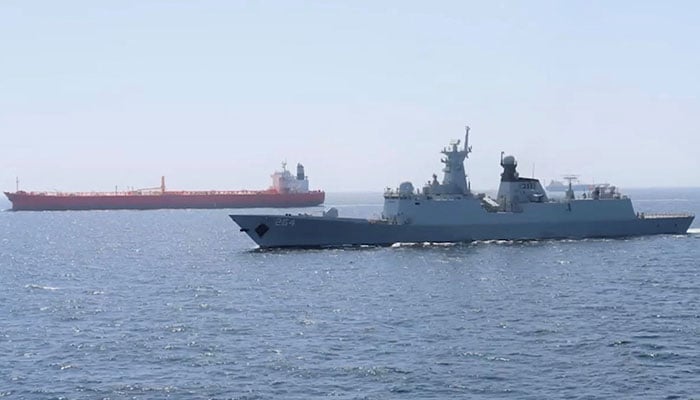 A PN ship escorts a Pakistani merchant vessel, as part of a maritime security operation, named Muhafiz-ul-Bahr, as regional tensions threaten key sea routes, amid the US-Israeli conflict with Iran, at an unidentified location, released on March 9, 2026. — Reuters
