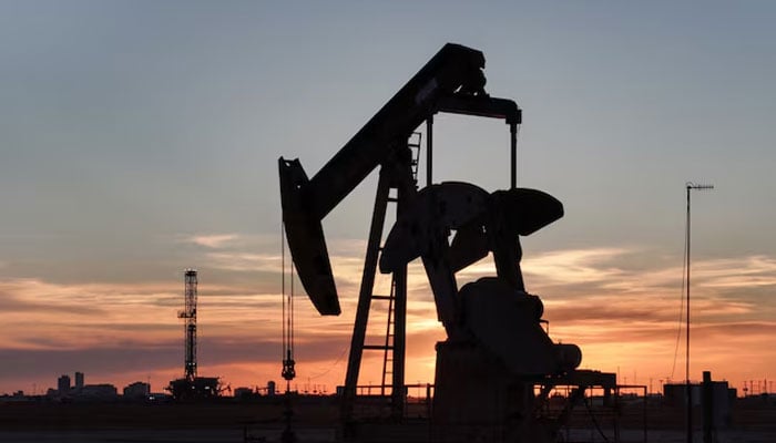 A drone view of a pump jack and drilling rig south of Midland, Texas, US June 11, 2025. — Reuters