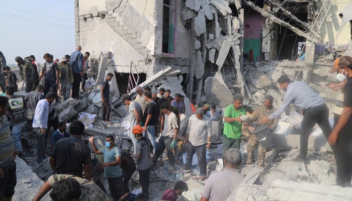 People search through the debris of the girls school in Irans Minab struck on February 28, 2026. — Reuters