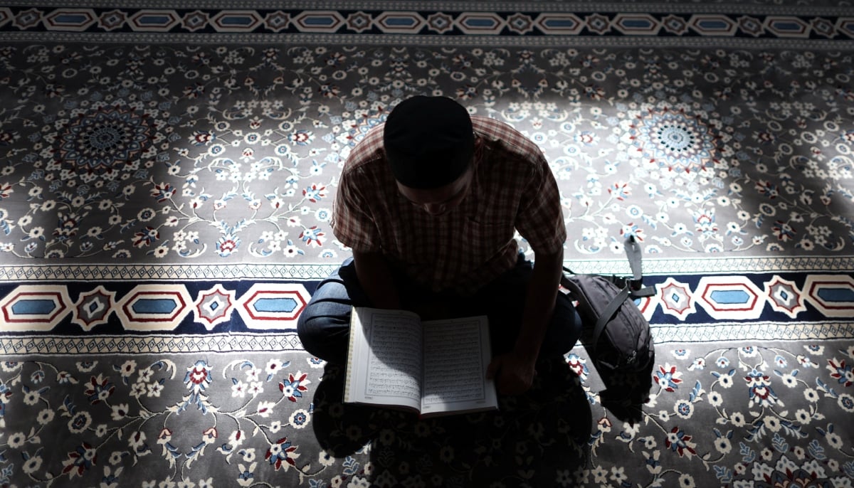 A Muslim man recites the Quran at a mosque during the holy month of Ramadan in Kuala Lumpur, Malaysia, March 5, 2026. — Reuters