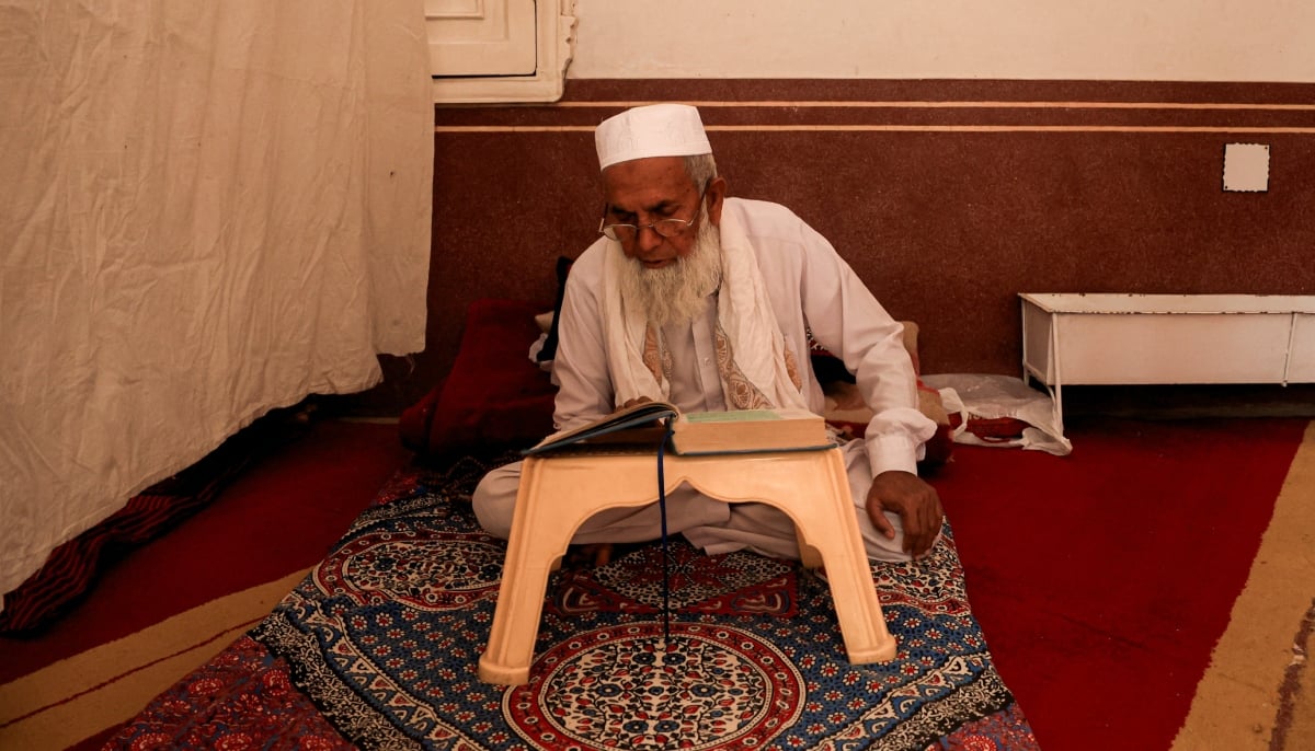 A man recites the Holy Quran while taking part in Itikaf at the Sunehri Mosque in Peshawar, March 10, 2026. — Reuters