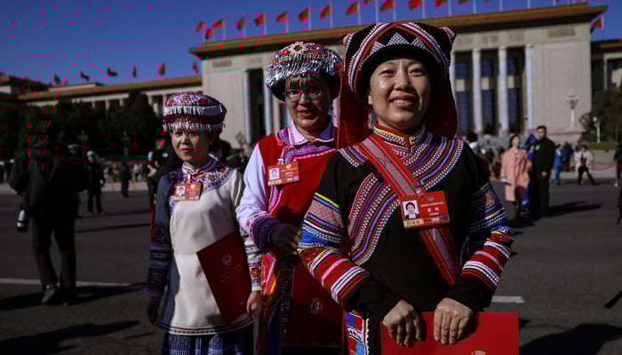 Delegates in ethnic minority costumes leave the Great Hall of the People following the closing session of the Chinese Peoples Political Consultative Conference (CPPCC), in Beijing, China, March 11, 2026. —Reuters