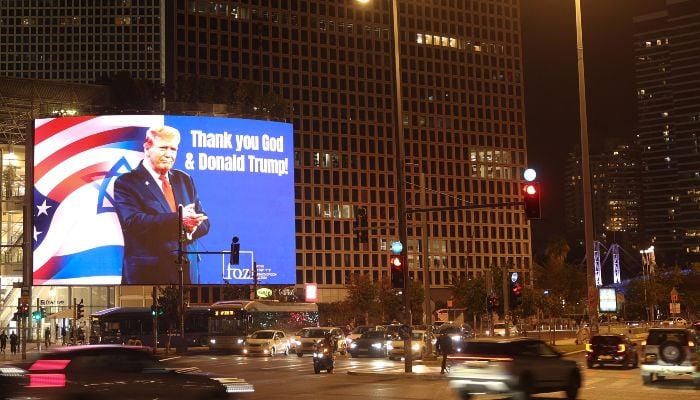 A billboard depicting an image of US President Donald Trump with a message thanking him is displayed on the side of a building in the Israeli coastal city of Tel Aviv on March 12, 2026. — AFP